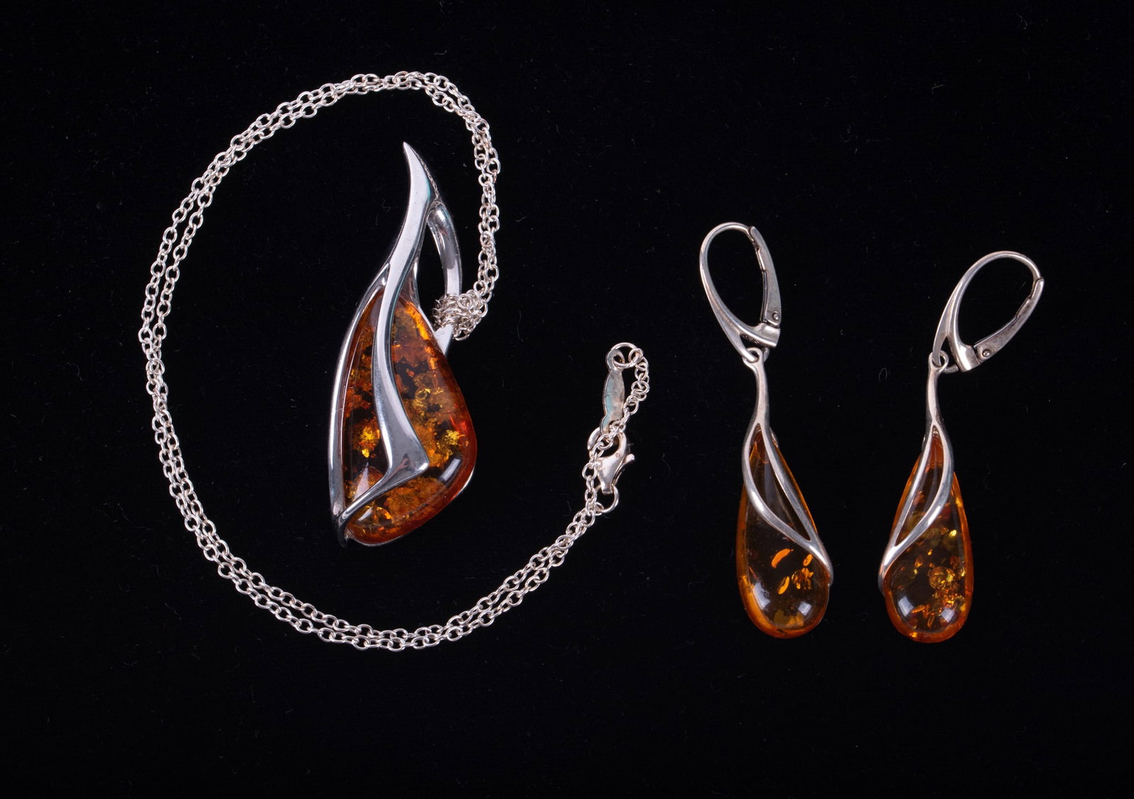 Sterling Silver Earrings & Pendant set with Amber: Sterling Silver Earrings & Pendant set with Amber The modernist pendant is 2 inches long and hangs from a 17 inch sterling chain. The earrings drop 2 inches.