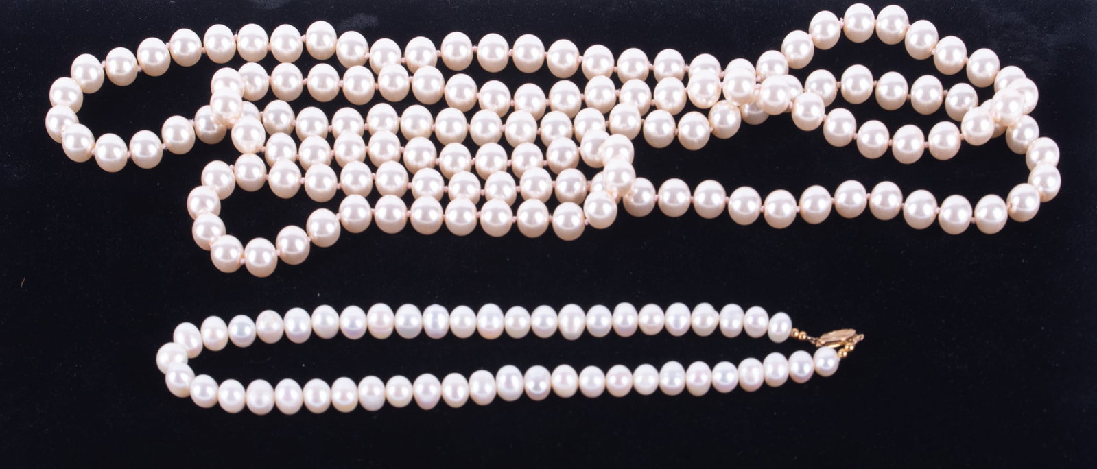 Strand Freshwater Pearls along with a Long Srand of Faux Pearls: Strand Freshwater Pearls along with a Long Srand of Faux Pearls The Freshwater pearls are potato shaped and measure 16 inches long. The 10mm faux pearls are 60 inches long.