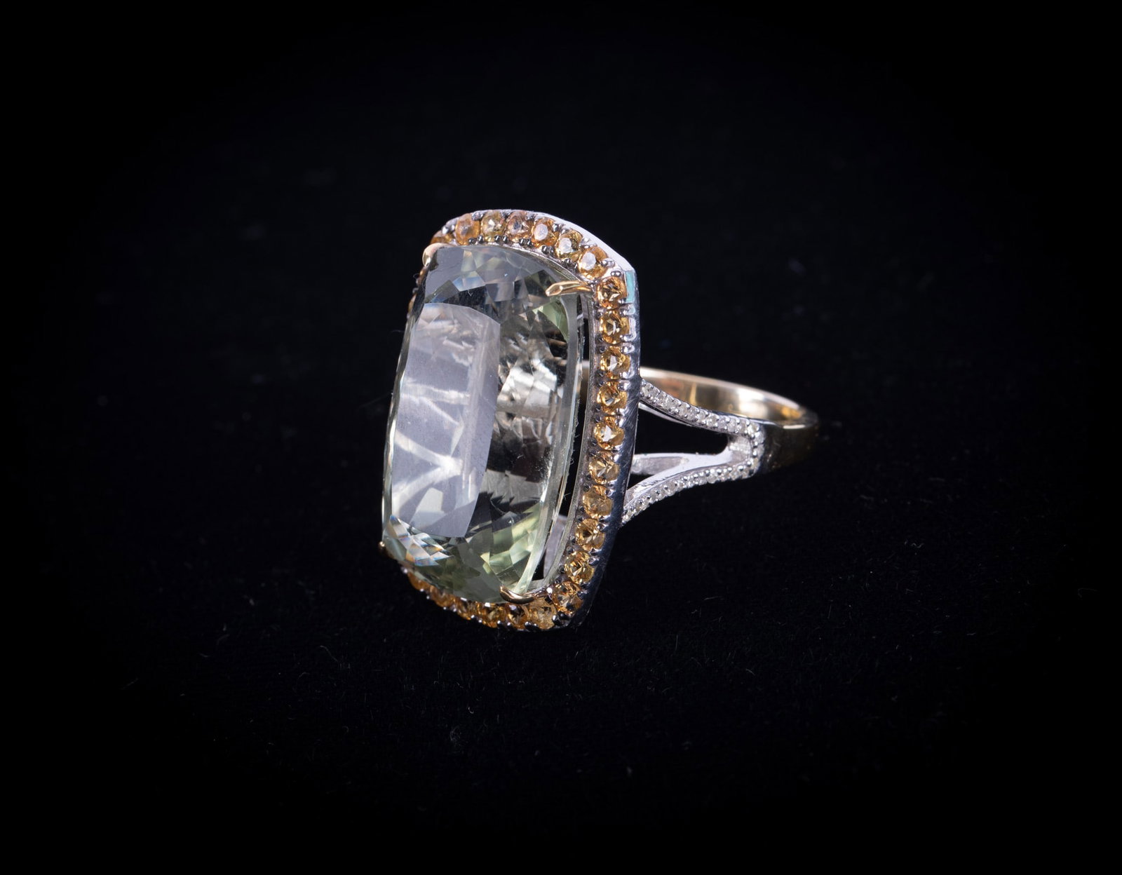 14K Yellow Gold & Sterling Silver Ring set w/Green Prasiolite: 14K Yellow Gold & Sterling Silver Ring set w/Green Prasiolite The prasiolite has a carat weight of 27.47 and is surrounded by 1.62 carats of orange sapphires. There are small diamonds trailing down ea