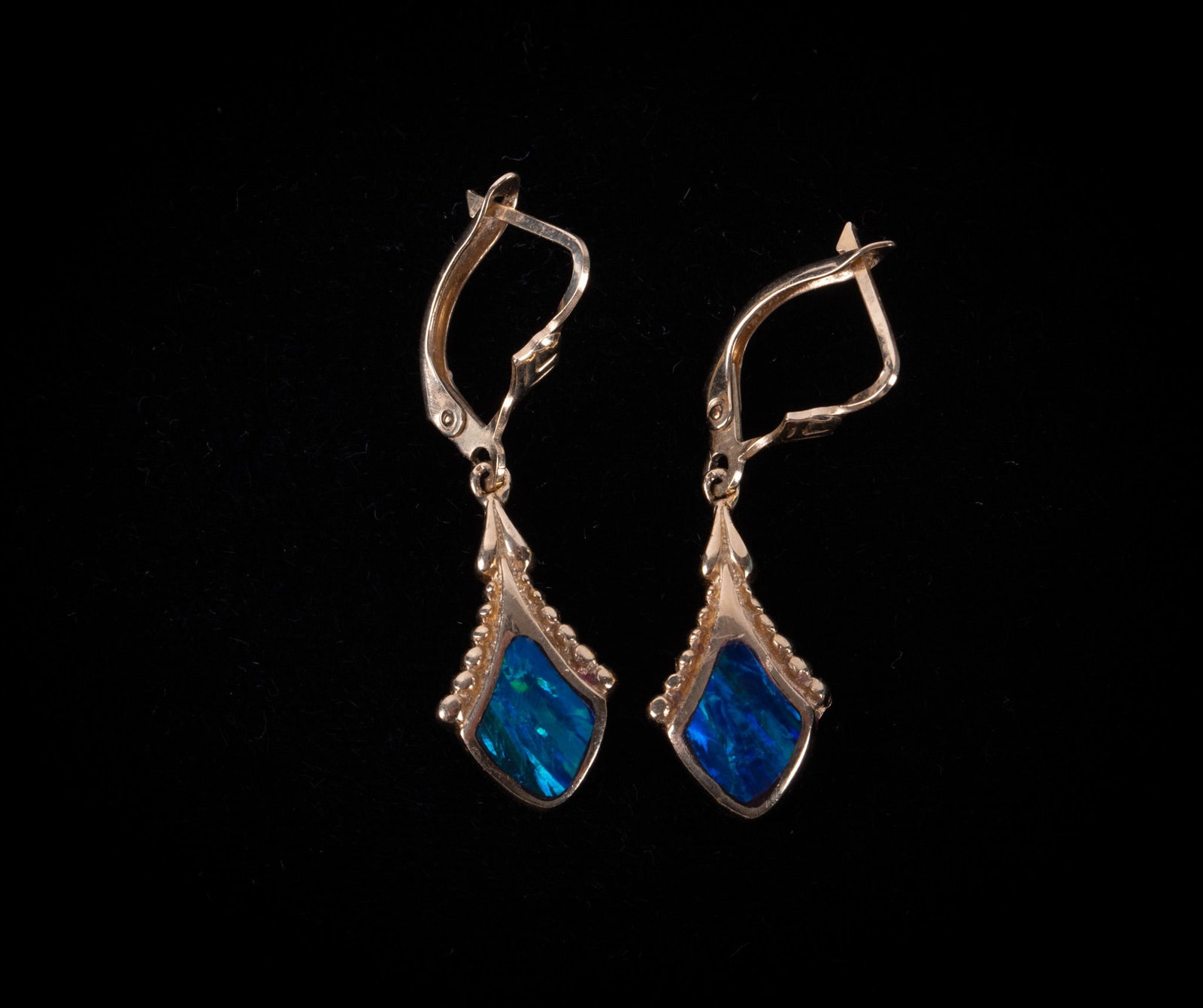 14K Yellow Gold Earrings set with Dichroic Glass: 14K Yellow Gold Earrings set with Dichroic Glass The weight on these earrings is 4.1g including stones. The drop is 1 1/4 inches.