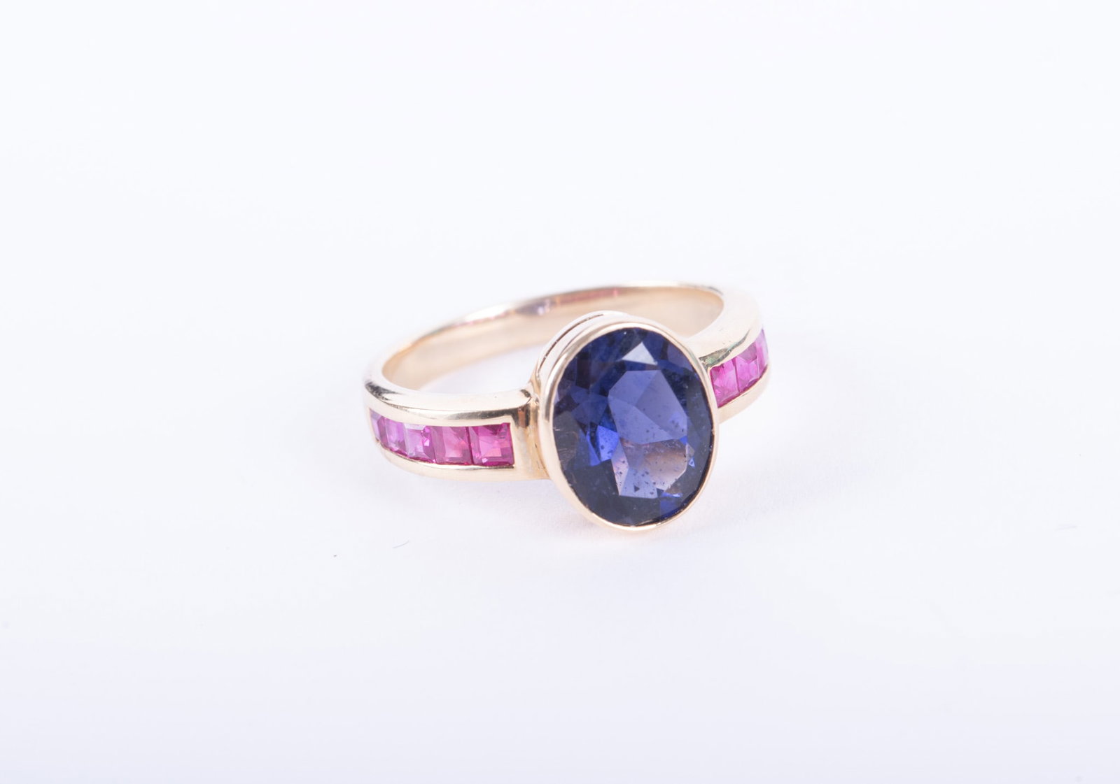14K Yellow Gold Ring set w/Iolite & Ruby: 14K Yellow Gold Ring set w/Iolite & Ruby The iolite in this ring measures 10mm x 8mm and there are 5 square cut rubies running down each side of the shank. Ring size is 8 and weight including stones i