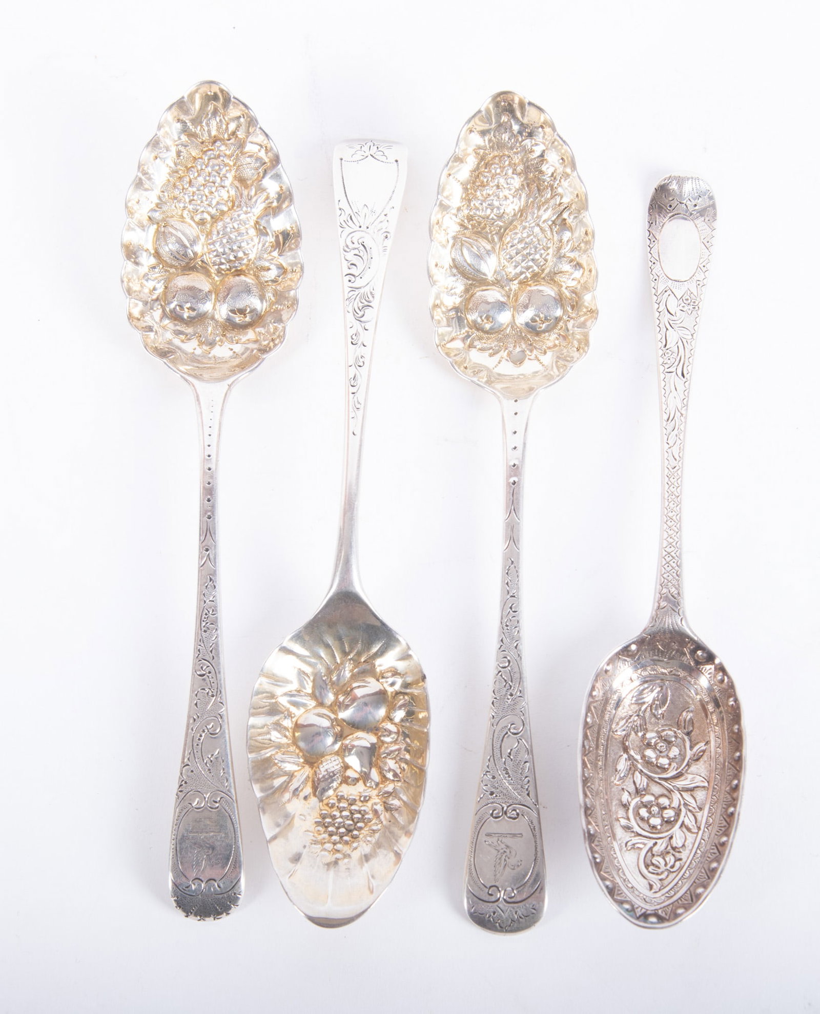 Four Georgian Sterling Silver Berry or Dessert Spoons: Four Georgian Sterling Silver Berry or Dessert Spoons London, late 18th/early 19th century, four large spoons with embossed fruit and floral bowls. By various makers including Richard Crossley, Willia