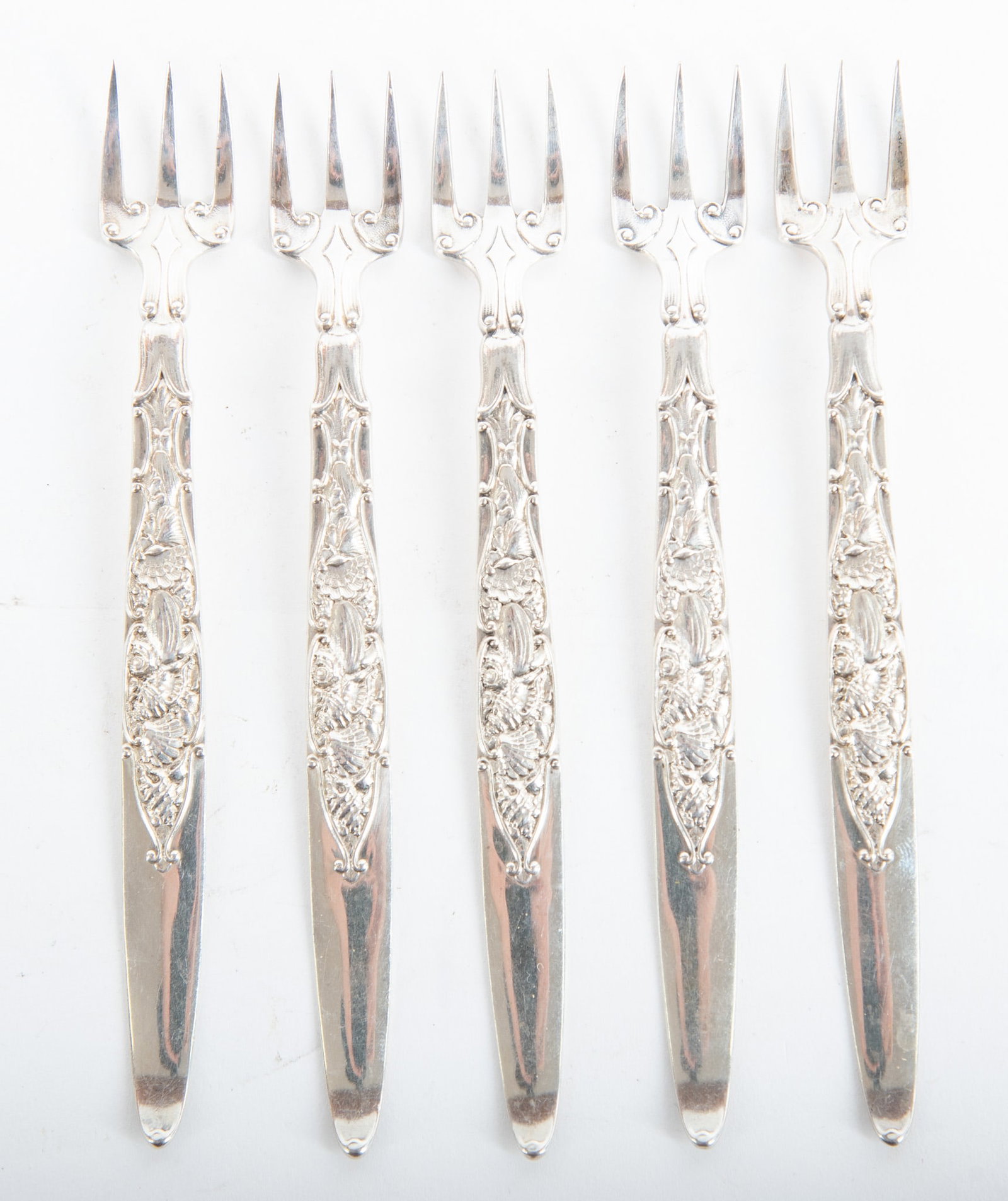 Sterling Silver Cocktail Forks by Gorham: Sterling Silver Cocktail Forks by Gorham This is an unregistered pattern by Gorham. There are five forks having a great pattern incorporating various kinds of seashells. Gross weight is 89.49g