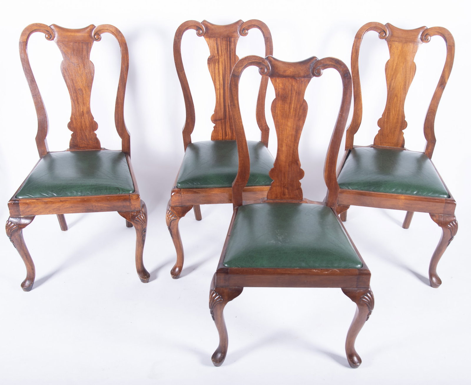 Set of Eight Queen Anne Design Dining Chairs: Set of Eight Queen Anne Design Dining Chairs Ribbon shaped back rail with a vasiform splat below with green leather upholstered seats resting on shell form carved cabriole legs. 39 x 21 1/2 x 22