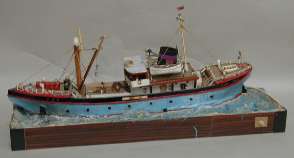A sailor's painted wood model of the a Shell Oil Co: A sailor's painted wood model of the a Shell Oil Company motor vessel, with electric wave motion, internal lighting and rotating radar mast - 86 cm long