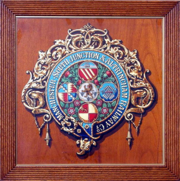 Manchester South Junction & Altrincham Railway Co.,: Manchester South Junction & Altrincham Railway Co., an original coat of arms crest, varnished transfer on fine wood panel, framed and glazed - 44 cm square