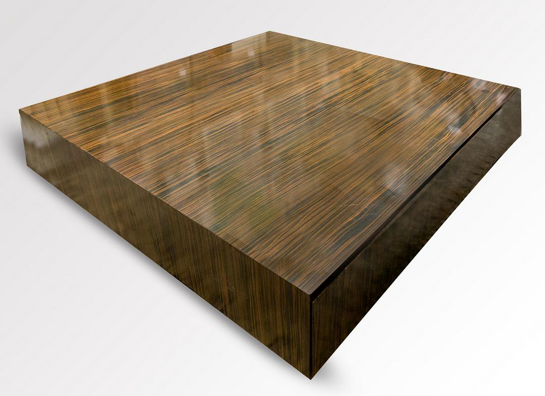 Makassar wood coffee table: Coffee table, probably Italian design, veneered with makassar ebony wood on the outside. Two drawers in the skirt with red lacquered interior. .