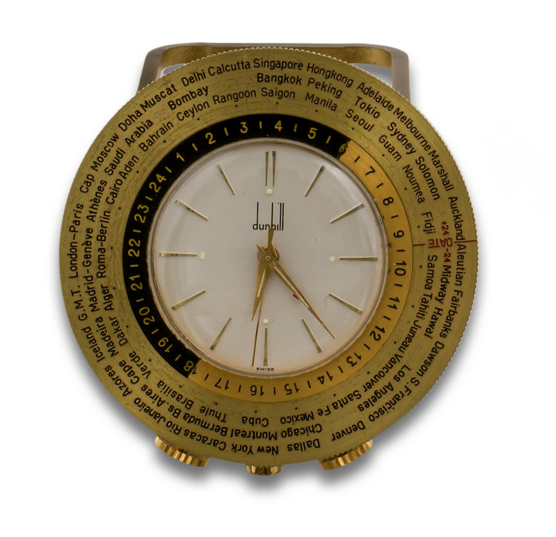 DUHILL GOLD METAL CLOCK: DUNHILL alarm clock, quartz movement, gold metal, white dial, index, bezel with Arabic numerals, world time, numbered 1687.