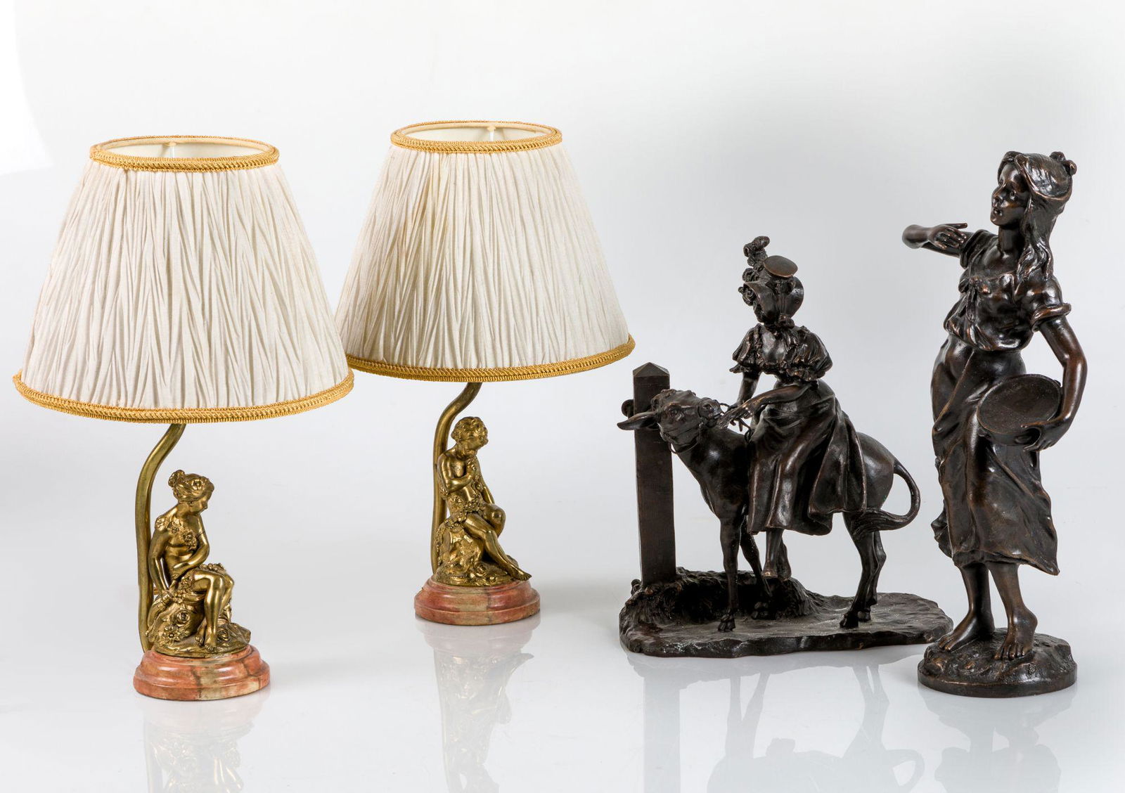 Woman with donkey bronze sculpture: Bronze group, representing a girl riding a donkey, after models by Ernest Wants, whose signature appears on the base. . .27 cm. height