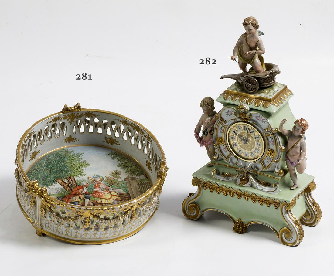 Naples porcelain clock: Porcelain table clock with Capodimonte markings. Glazed and polychrome decoration with cupids. . . 43 x 27 x 13 cm.