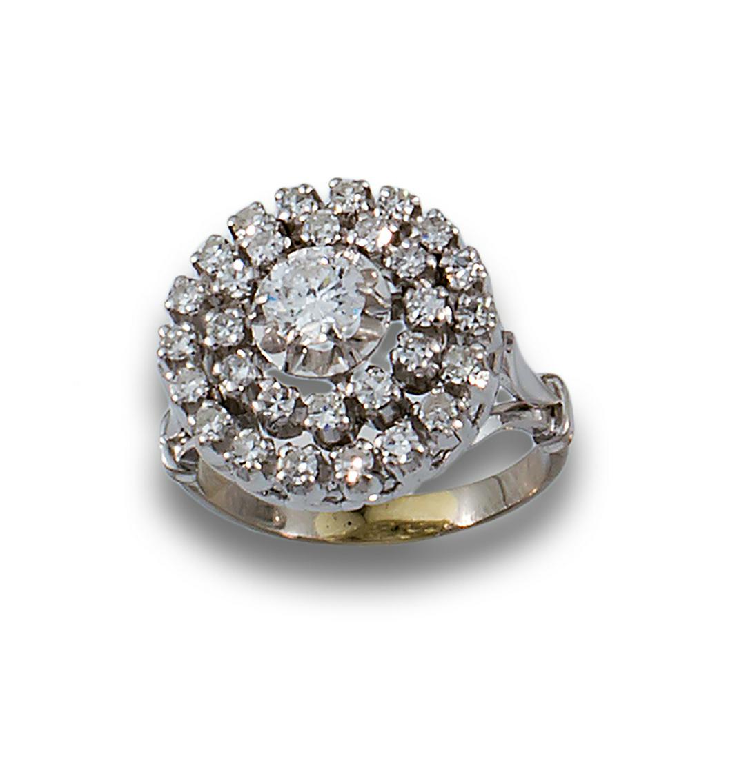 DOUBLE GOLD DIAMOND ROSETTE RING: 18kt white gold flower ring, centre with brilliant cut diamond, estimated weight 0.30cts and double border with brilliant cut diamonds