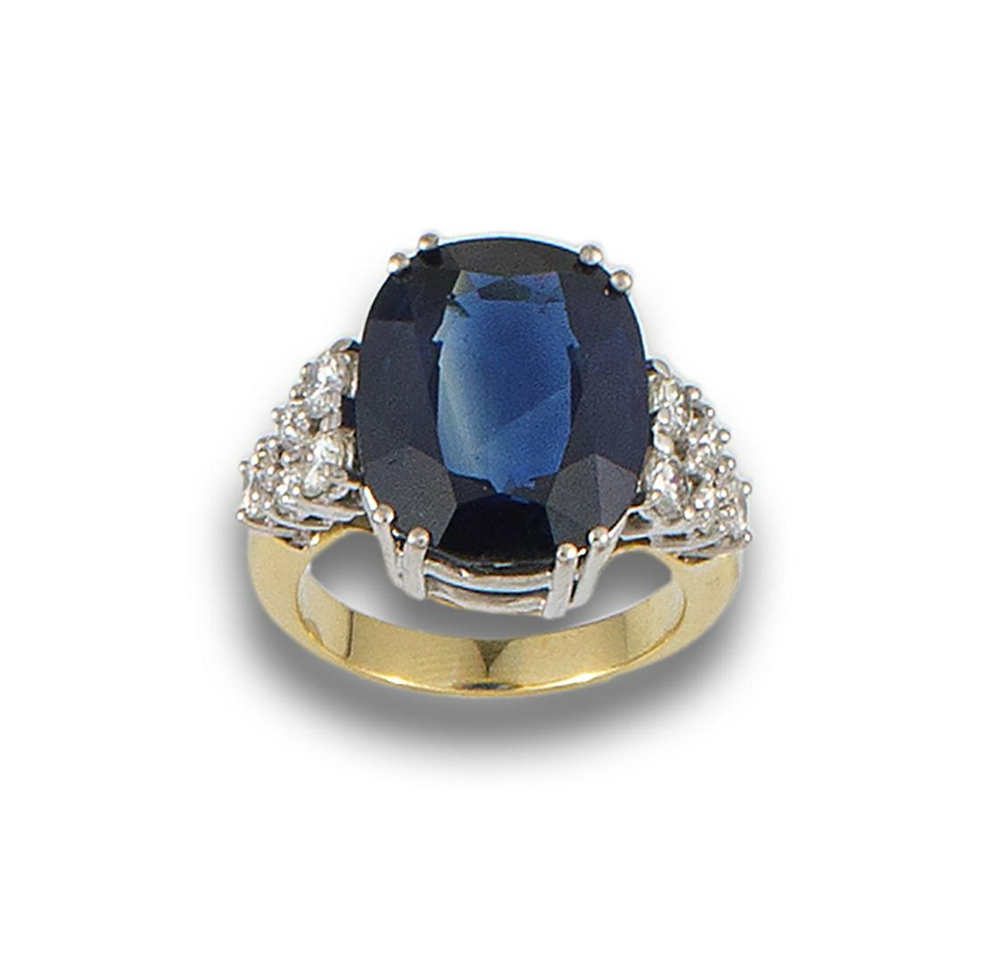 18kt. yellow gold ring with 18kt. white gold overtones formed by a central oval-cut sapphire. (1 of 1)