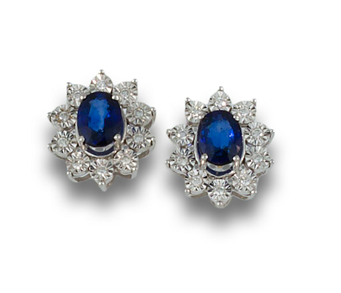 18kt white gold rosette earrings made up of central oval-cut sapphires, bordered with diamonds. (1 of 1)