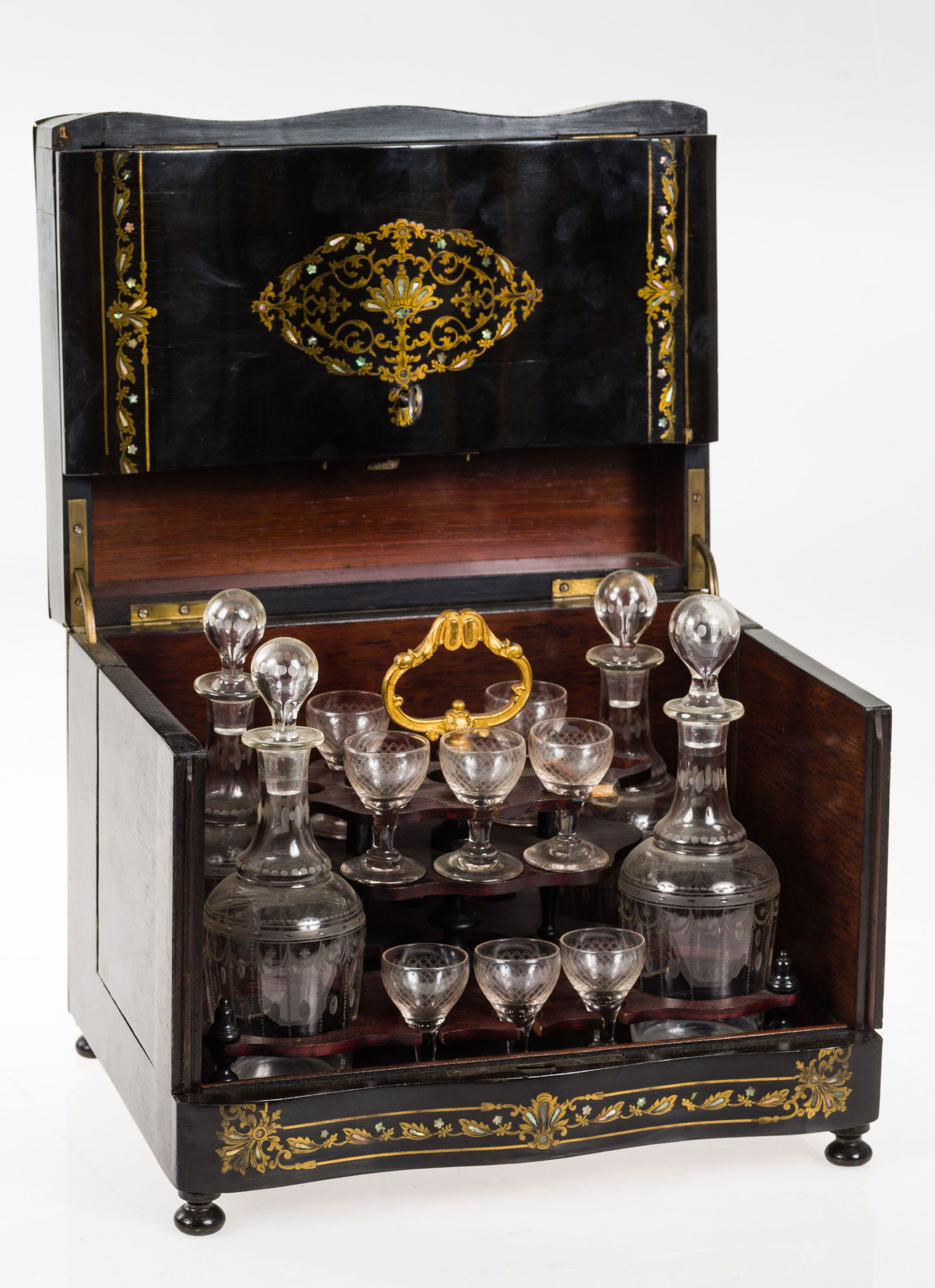 With four decanters and eight glasses inside in acid etched glass. Measurements: 26 x 32 x 24 cm, (1 of 1)