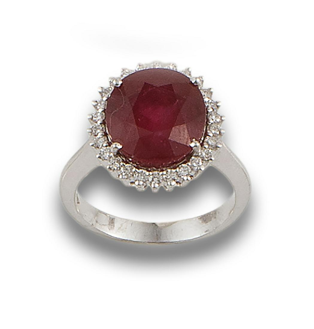 Formed by a central ruby, oval cut, estimated at 5.50 ct. bordered with diamonds, brilliant cut. (1 of 1)
