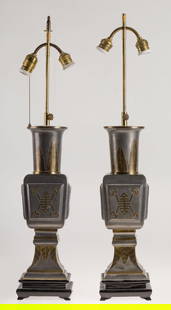 Pair of table lamps, mid. 20th century: Pewter and gilt brass decorated with oriental motilate On ebonized wood base. Small faults. Measurements: 80 cm each