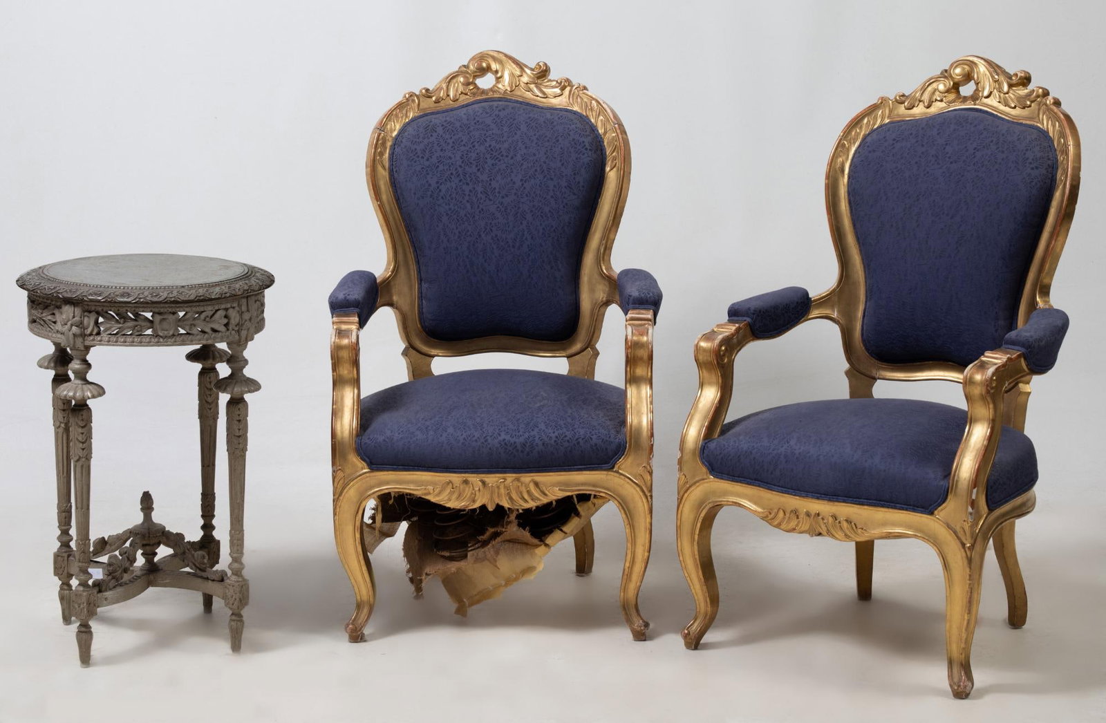 Pair of Louis XV style armchairs, 20th century: Made of carved and gilded wood with backrest finished in rockery. Failures and restorations. Bottomless seat. Measurements: 110 x 62 x 57 cm