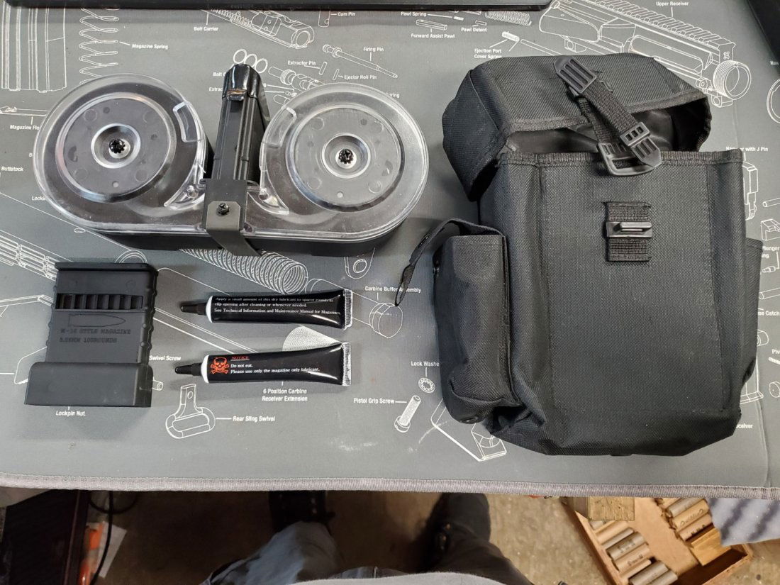 100 round ar15 .223 / 5.56 drum magazine: 100 round ar15 5.56 drum magazine with holder, 2 graphite tubes, and easy loader all conveniently held in pouches on side of main cloth holder! See pictures. Looks brand new to my eye!