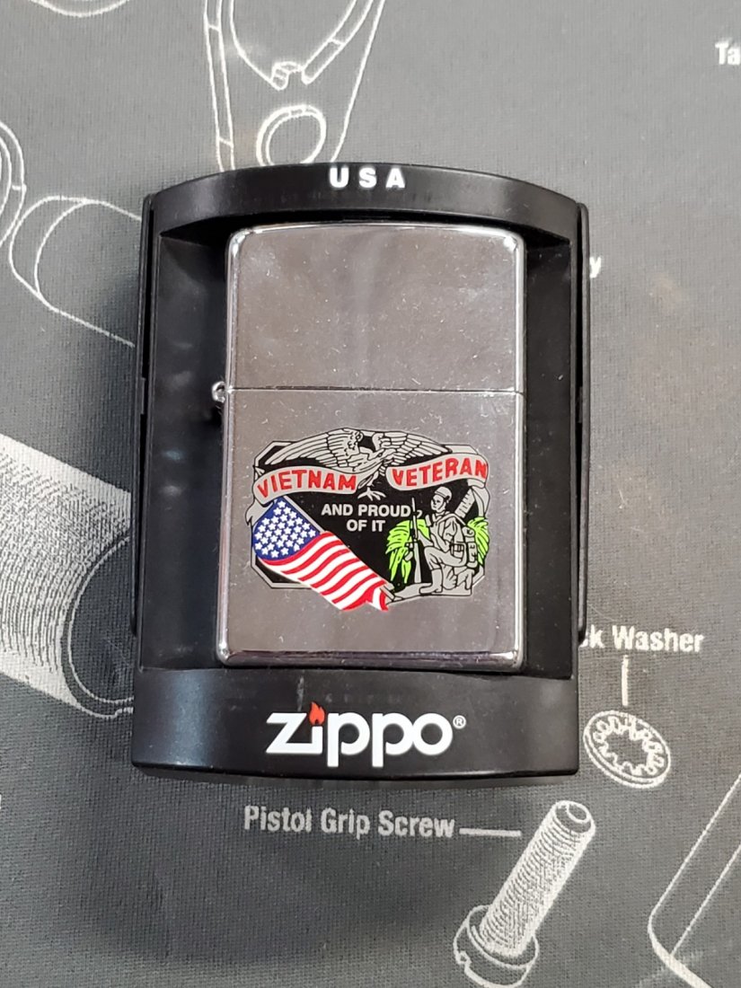 unfired sealed vietnam veteran zippo j 30: looks like it's still sealed, with the sticker on the back; I am therefore assuming it is unfired. excellent shape. See pictures!GRADES ON THE SLEEVES ARE FROM THE PREVIOUS COLLECTOR/OWNER. I MAKE NO 