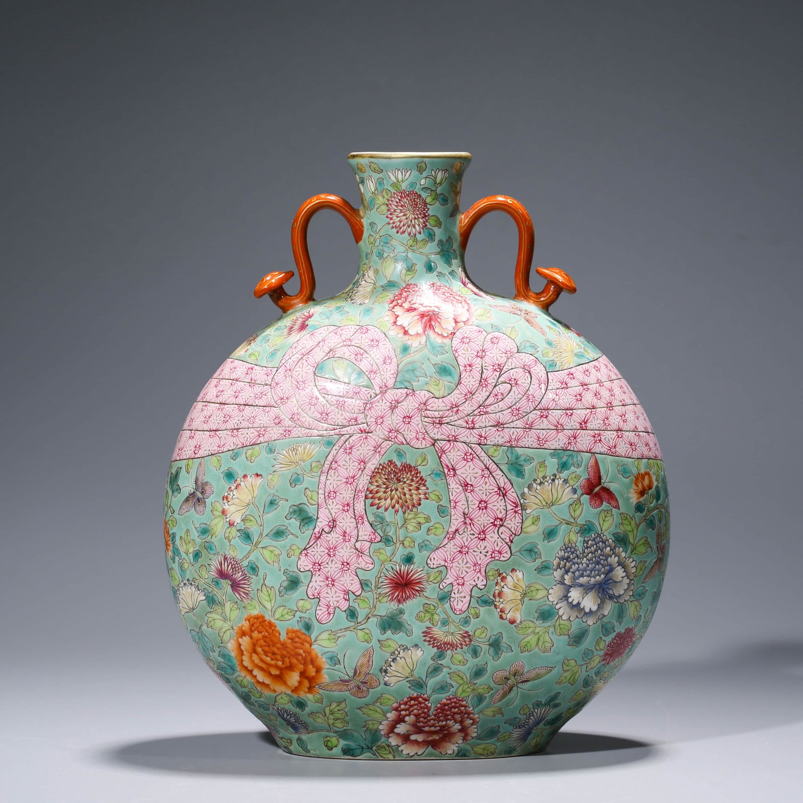 A CHINESE FAMILLE ROSE PORCELAIN MOONFLASK, QIANLONG: Dimensions: Length: 22.4cm, Width: 13.8cm, Height: 26.5cm, With twin handles, painted with butterflies and poenies among stylised lotus sprays and an obvious knot on a pale turquoise ground, indeciphe