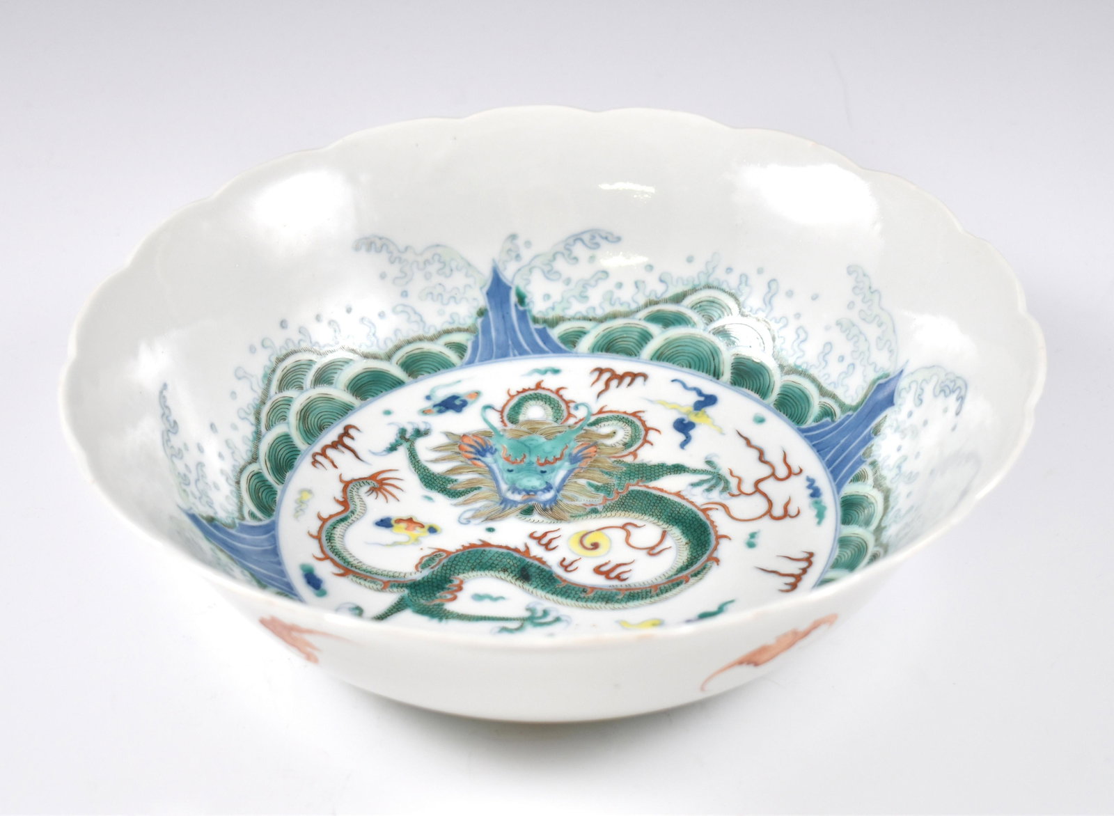QIANLONG RED FU BATS PORCELAIN BOWL: Dimensions: 3-1/4" H x 9-7/8" Dia. Chinese Qing Dynasty Period, QianLong Fu bat bowl. The porcelain potted with a shallow body, slight deep, broad cavetto, with slight flaring opening lip, and wavy sh