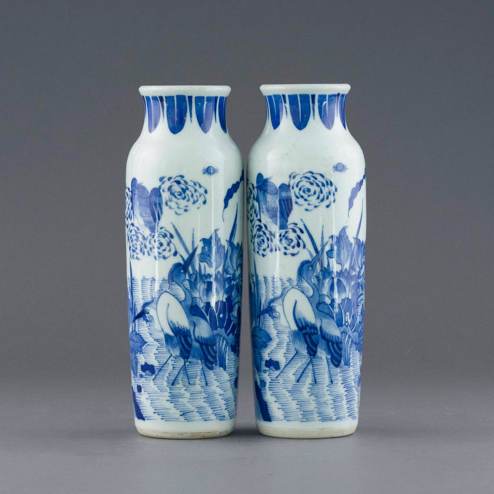 PAIR MING BLUE & WHITE FIGURINES ELEPHANT LEG VASES: Dimensions: 10.625in H x 3.625in W x 3.625in D Pair of Chinese Ming Dynasty Period, blue and white elephant leg vases. The porcelain potted in tall baluster forms vase, with cylindrical body tapered t