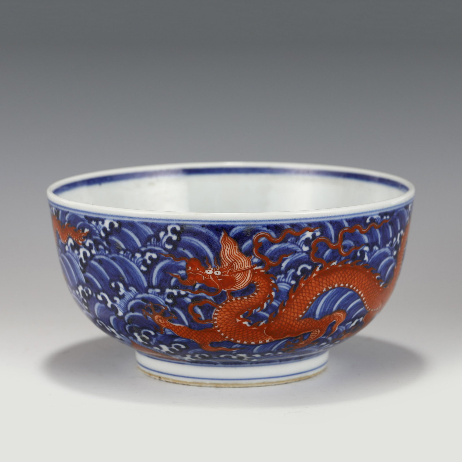 MING XUANDE DRAGON BOWL: Dimensions (cm): Heigth: 9.3ã€€Diam.: 18.3 Chinese Ming Dynasty XuanDe Blue and Red Dragon Porcelain Bowl. The bowl has an open mouth, rounded lip rim, thick, deep arced body, raised with round f