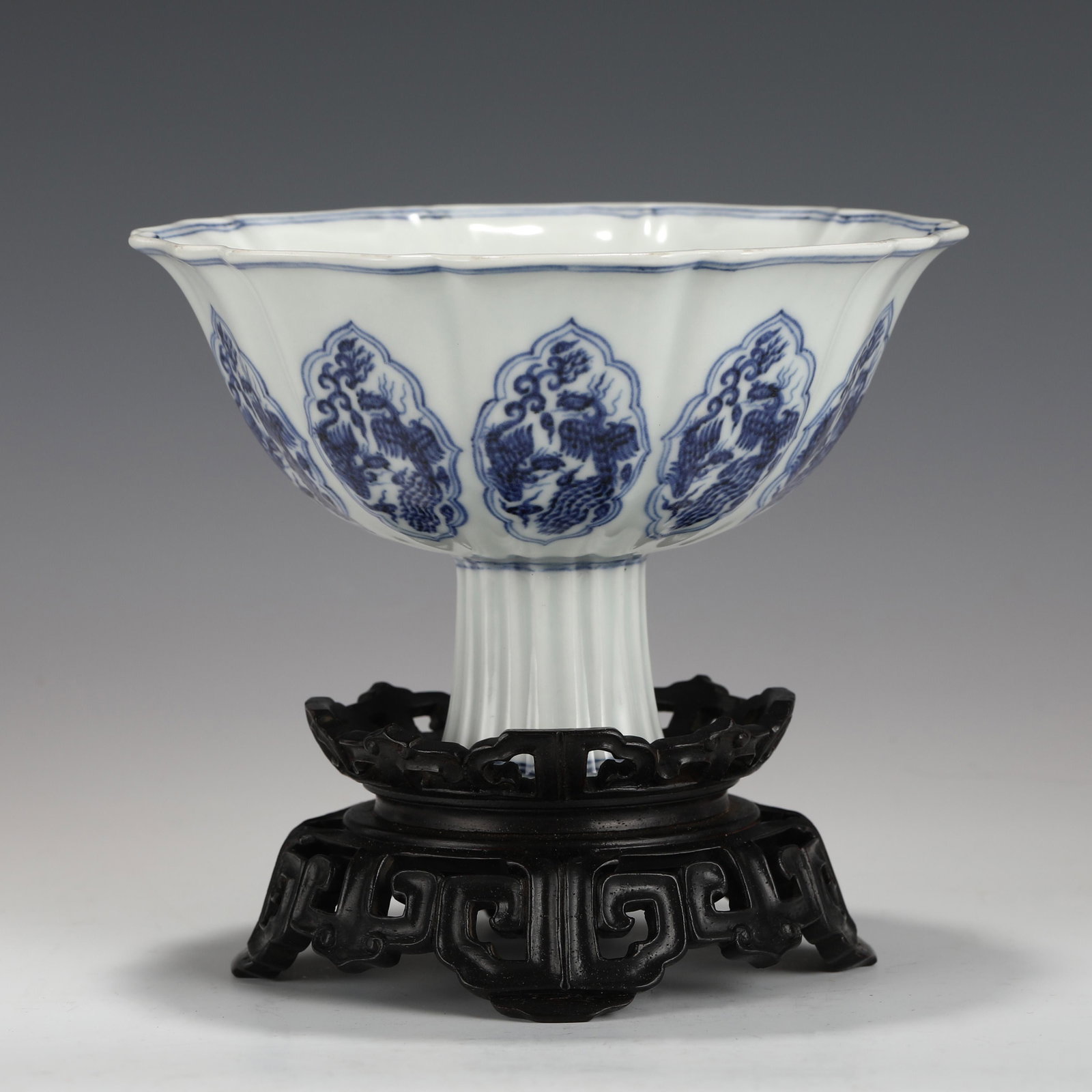 XUANDE HIGH-FOOT BOWL: Dimensions (cm): Heigth: 11 Diam.: 16.2 Chinese Ming Dynasty XuanDe Blue and White Flori Porcelain High Foot Bowl On Carved Hardwood Stand. The porcelain potted with a shallow body, slight deep, thick