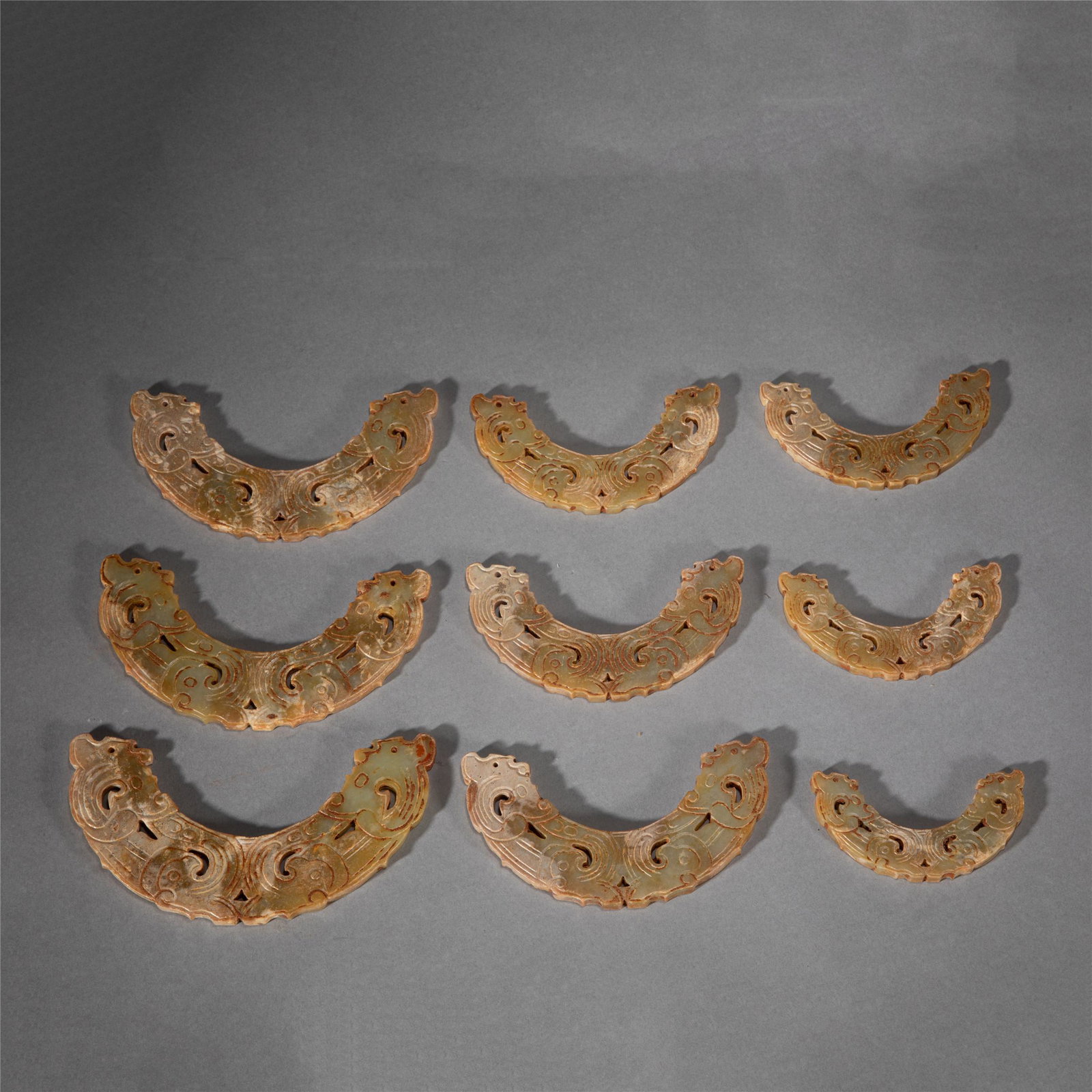 A GROUP OF NINE JADE BI ORNAMENTS (1 of 10)
