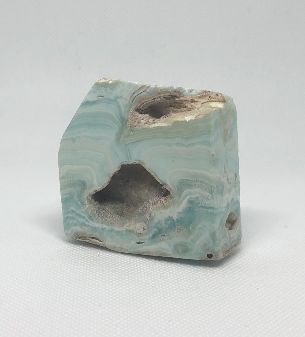 Blue Aragonite Freeform: Very pretty blue aragonite freeform with natural vugs. Approx 2.25" x 2.5" x .75". Pakistan. AS ALWAYS WE OFFER IN-HOUSE SHIPPING VIA USPS FLAT RATE SHIPPING, NO EXTRAVAGANT SHIPPING FEES!