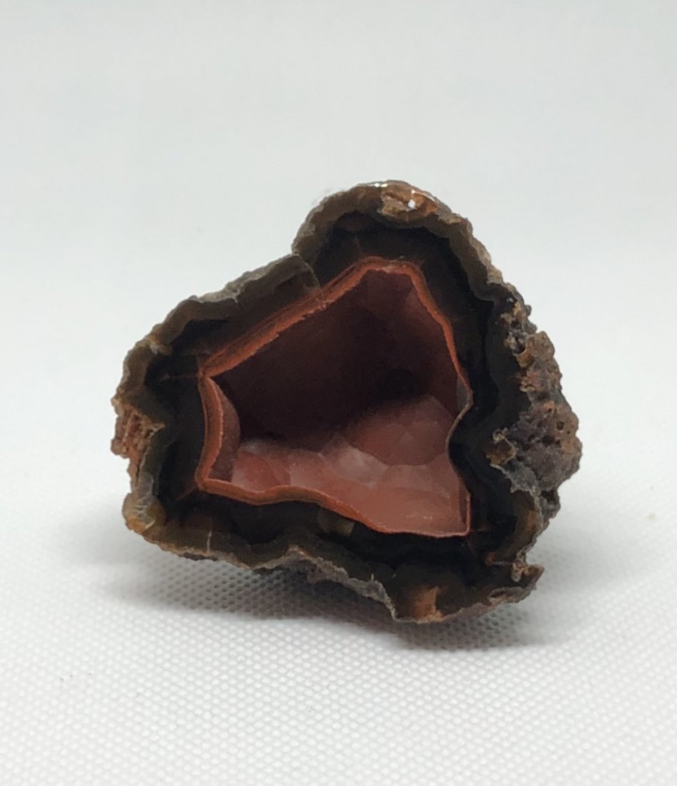 Red Fox Agate Geode Half: Red fox agate geode half. These geodes are rare hematite included and are UV reactive. Argentina. Weight is 77.4 grams. AS ALWAYS WE OFFER IN-HOUSE SHIPPING VIA USPS FLAT RATE SHIPPING, NO EXTRAVAGANT