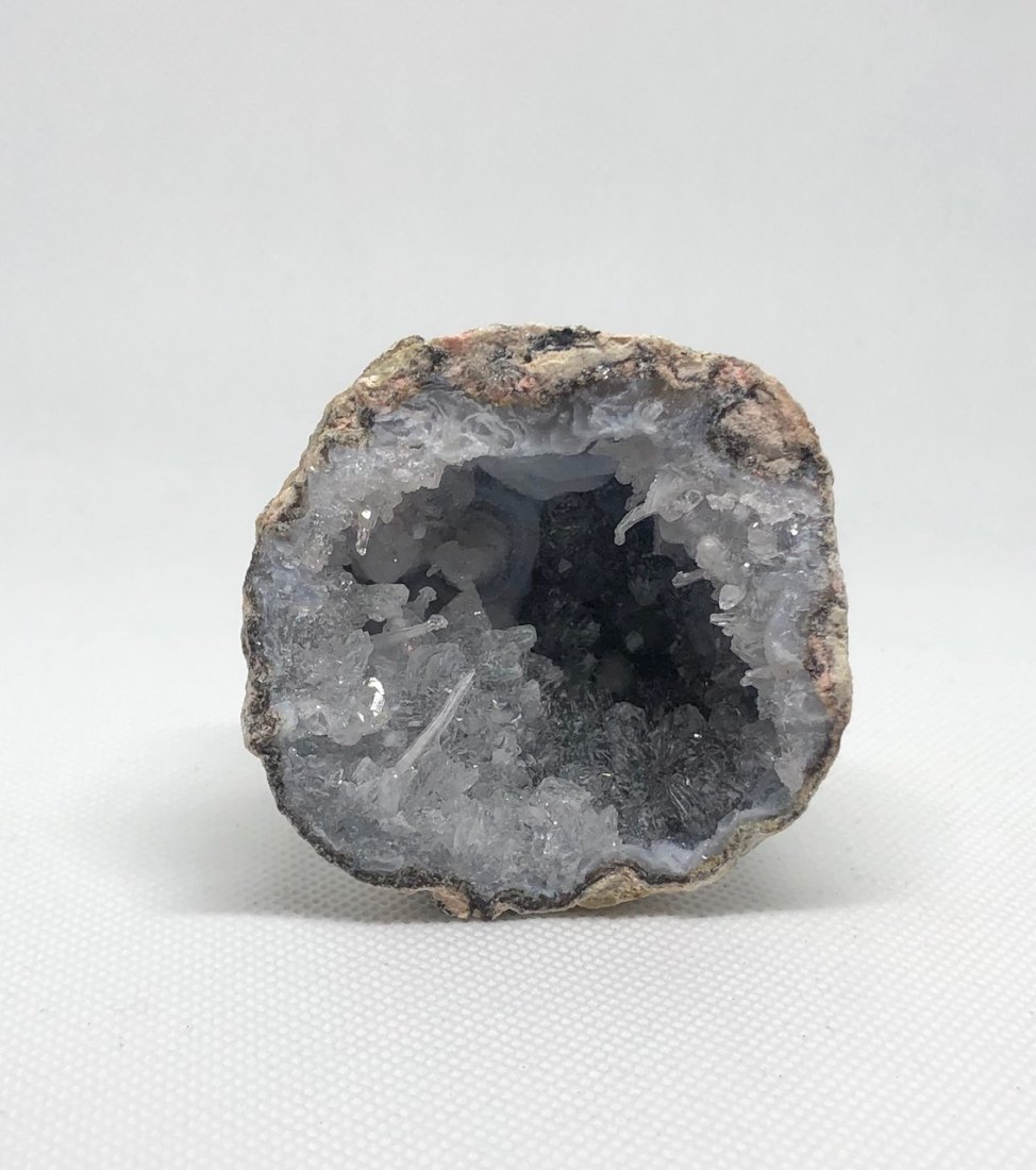 Small Geode Half: Amazing landscape in this small geode half. Blue agate with druzy and stalactitic quartz. Very pretty. Approx 2.5" diameter. AS ALWAYS WE OFFER IN-HOUSE SHIPPING VIA USPS FLAT RATE SHIPPING, NO EXTRAV