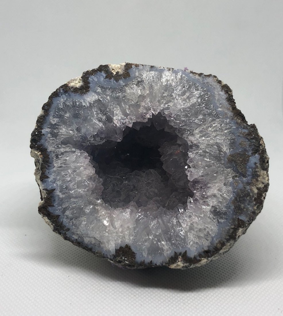 Geode Half: Beautiful geode half with blue agate rim and nice crystallization. Approx 3.5\" diameter. AS ALWAYS WE OFFER IN-HOUSE SHIPPING VIA USPS FLAT RATE SHIPPING, NO EXTRAVAGANT SHIPPING FEES!