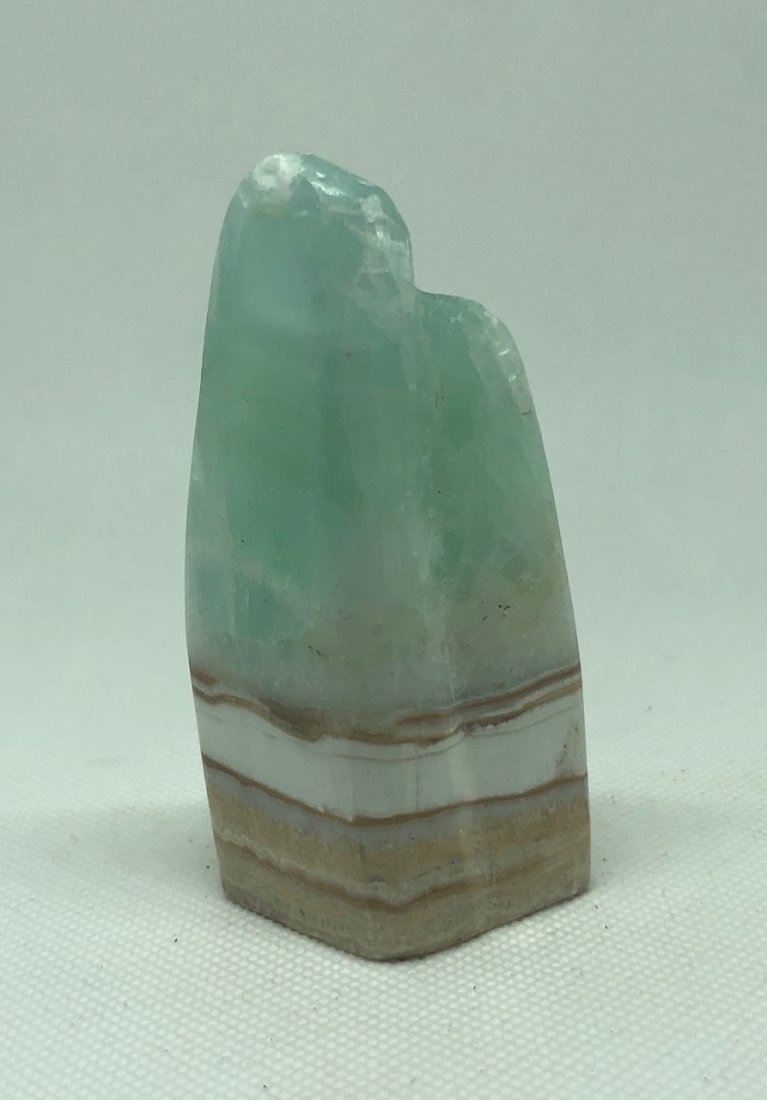 Blue "Caribbean" Calcite Freeform: Very nice blue "caribbean" calcite freeform with two pointed shape. Approx 3.5" x 1.5". AS ALWAYS WE OFFER IN-HOUSE SHIPPING VIA USPS FLAT RATE SHIPPING, NO EXTRAVAGANT SHIPPING FEES!