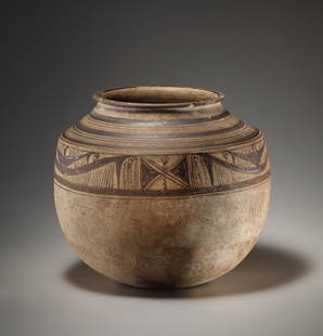 A Large Storage Vessel with Double Frieze of Birds: West Asian ca. 2000 B.C..Light beige tone, dark to light brown matt slip. H. 27.2 cmThe large vessel with a distinctive shoulder and flared mouth stands on a round base. The shoulder is encircled