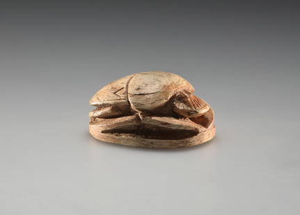 A Scarab: Egyptian, Late Period 664-525 B.C..Steatite. L. 3.1 cmSeal amulet in the form of a scarab. A hieroglyphic inscription on the flat base. Fragment missing on one long side of the base.