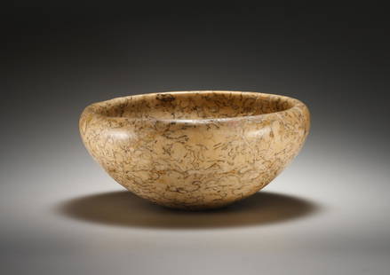 A Bowl: Egypt Early Dynastic or Old Kingdom, 1st-6th Dynasty, ca. 3000-2200 B.C..Yellowish stone with dark inclusions. Dm. 18.6 cmDeep, conical stone vessel with a thick wall that curves inwards elegantly. Re