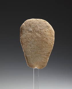 Body of a Schmatically Rendered Idol: Anatolian, Early Bronze Age 3rd millenium B.C..Marble. H. 6.9 cmThe body is designed as a flat disc; on the underside the semicircular contour finished with sharp edges. In the upper, tapered area,