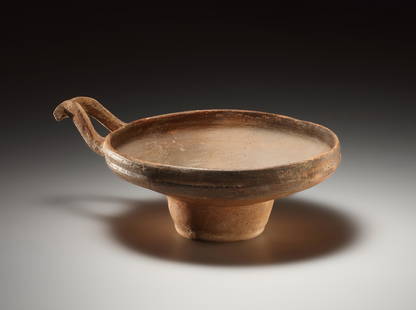 A One-handled Cup (Base Ring Ware): Eastern Mediterranean, Late Bronze Age 1475-1225 B.C..Clay. Dm. 16.7 cmWide bowl with vertical rim and S-shaped stirrup handle. Cylindrical foot moulded out of the base of the bowl. Foot worn,