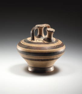 A sub-Mycenaean Stirrup Jar: Greek, sub-Mycenaean ca. 11th cent. B.C..Clay. H. 17 cmA sub-mycenaean stirrup jar with flaring body, tall spout, and abstracted vegetal motifs on the shoulder. Concentric bands alternating with