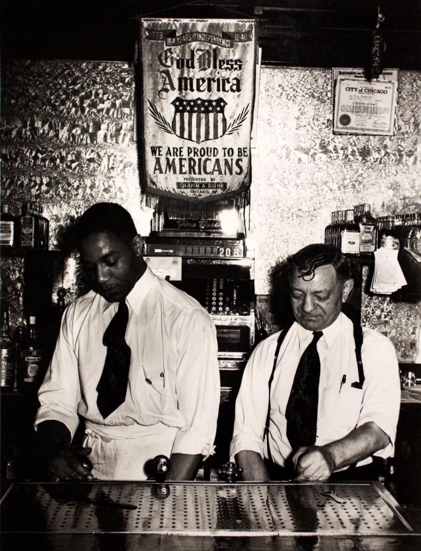 RUSSELL LEE Bar Scene Chicago Illinois 1941: RUSSELL LEE Bartender and owner of a tavern on the South Side, Chicago, April 1941, 9.3x7.3" on 8x10" paper Gelatin Silver print printed later ASG# RL/1238 Signed on right margin For Bill Russell Lee,