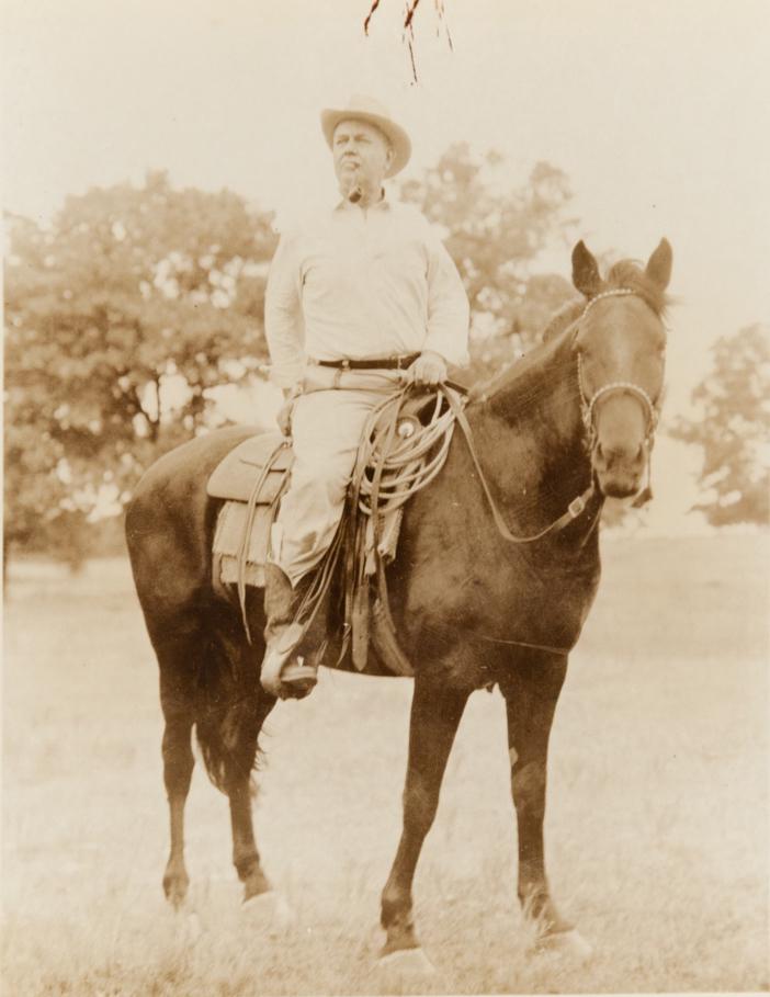 ERWIN SMITH TEXAS HISTORIAN AUTHOR J. FRANK DOBIE: ERWIN SMITH J. Frank Dobie, 1941 5.35x4.5" Silver Collodion Print ASG# EES/1572 on 7x5" paper typed beneath print "J. Frank Dobie Credit: Erwin E. Smith". Here Dobie is mounted on one of his favorite