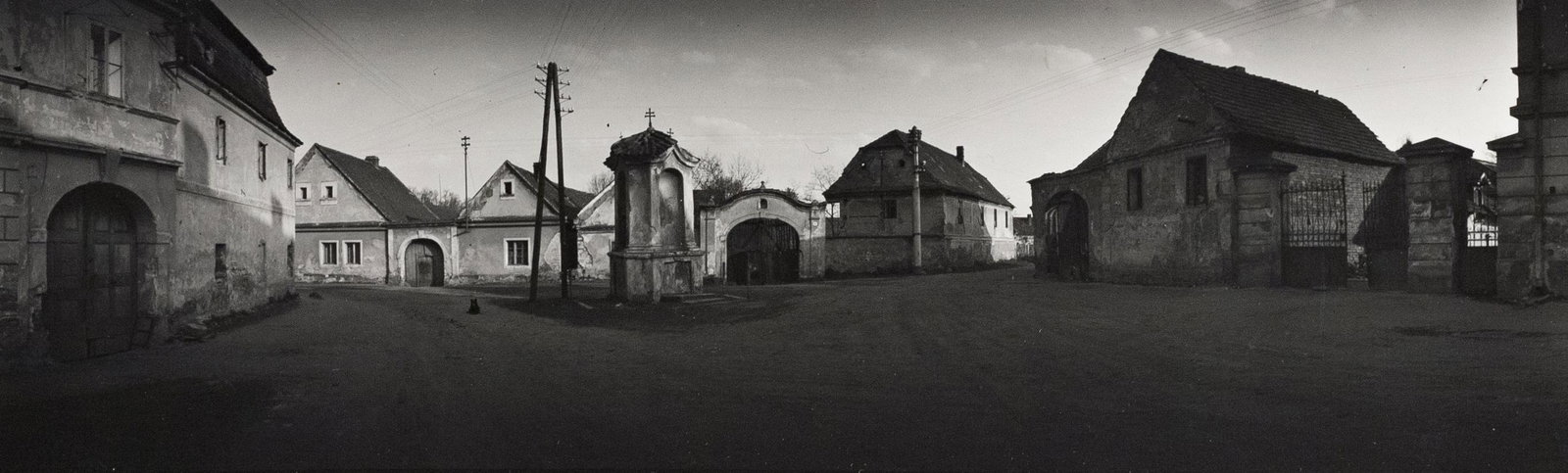 JOSEF SUDEK Czech Neighborhood 1950s panorama: JOSEF SUDEK, Untitled (Village Street), 1957, 3.375x11.25" Gelatin silver print, Printed c. 1957, Dated and inscribed in Czech in pencil on print verso. Sudek's panoramas from the 1950s were a tremend