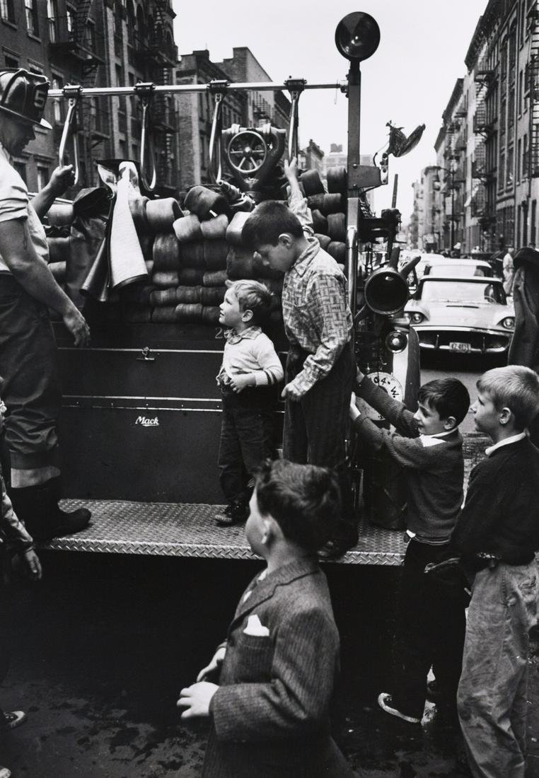 KEN HEYMAN Kids on Fire Truck: KEN HEYMAN, Kids on Fire Truck, artist's stamp verso, c. 1960s, 12.875x9" gelatin silver print, printed c. 1960s. Stamped twice in blue and black ink on print verso: Please Credit / Ken Heyman / Sixty