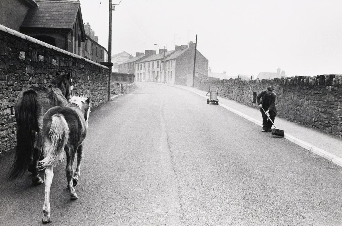 BRUCE DAVIDSON Sweeping the Roadway Wales: BRUCE DAVIDSON, (Sweeping the Roadway), from Welsh Miners series, 1965, 8x12", gelatin silver print, printed C. 1970S. Signed and titled in pencil on print verso; inscribed in pencil: P. 125 / O BD 02
