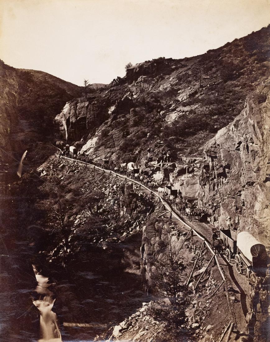 CHARLES WEITFLE Wagon Train 1883 Colorado: CHARLES WEITFLE, 21 Indian Supply Train, Ute Pass [Colorado], c. 1883, 12.8x10.1" albumen print, Printed c. 1883, Printed title in negtive. Classic view of the mule team wagon supply descending Ute Pa