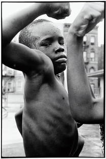 LEONARD FREED Harlem Portrait 1963 Highlight: LEONARD FREED. Muscle Boy, Harlem, c. 1963. 14x11" gelatin silver print. Printed c. 1970s. Embossed on print recto: c. Leonard Freed. Signed in pencil on print verso; inscribed in pencil: 1963 Harlem,