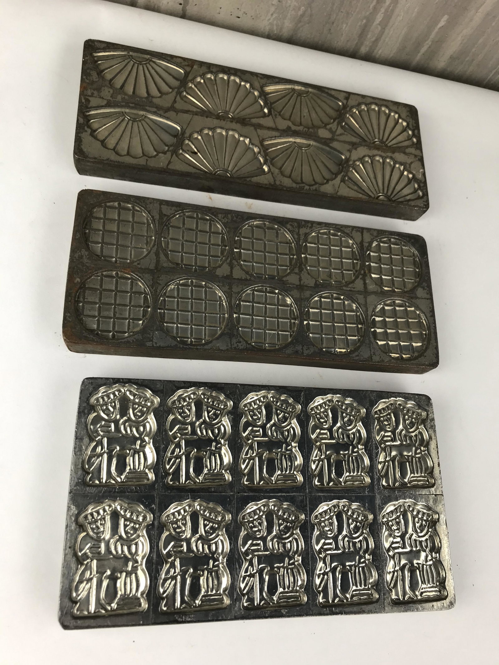 Lot of Three Vintage Chocolate Molds: Great grouping of three vintage metal chocolate molds from a Belgium chocolate factory. 8"-10" Long. 3.75"-5" Wide. .5"H