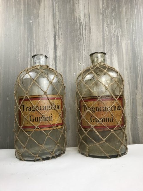 Lot of 2 Vintage Style Apothecary Jars: Lot of two vintage style apothecary jars wrapped in rope mesh. Great shelf décor!