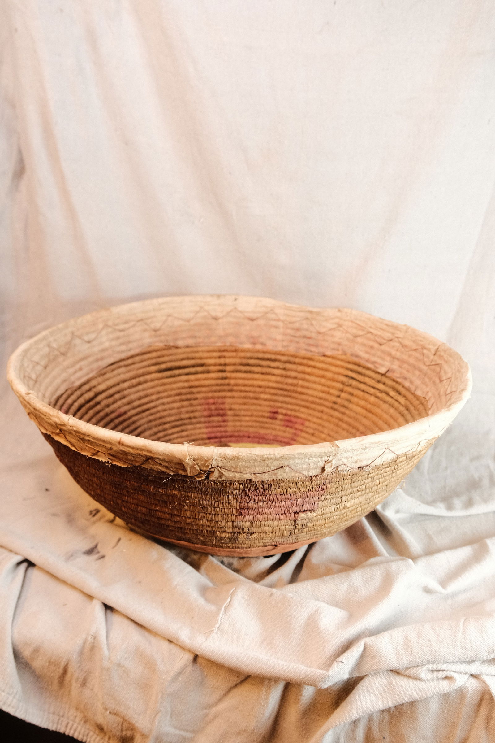 Oversized Disk shaped Woven Basket with decorative cloth accent (1 of 5)